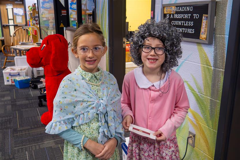two girls dressed as 100 year olds in the library